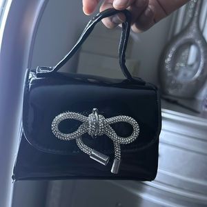 Little black bag, with silver bow.